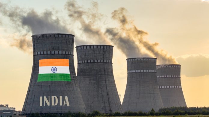 Nuclear plant chimneys displaying flag of India with according text. Energy pollution accidents in the country concept. Power production and generation from atomic energy.