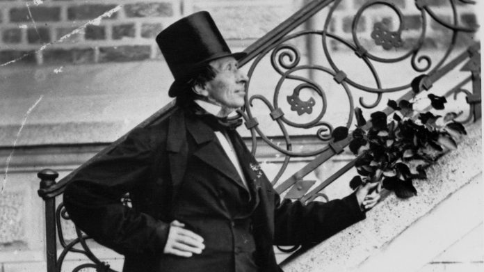 Hans Christian Andersen Posing Next to Stairway