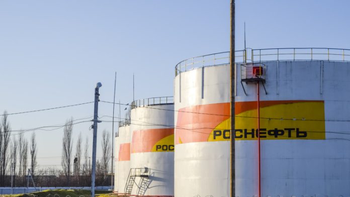Reservoirs with fuel at the oil depot of Rosneft. Tanks in the light of the setting sun.