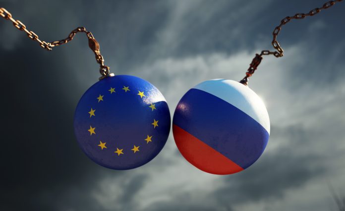 Wrecking Balls Textured with European Union and Russian Flags Over Dark Stormy Sky
